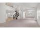 Expansive living room with soaring ceilings, a staircase, and arched doorways for a luxurious feel at 3166 E Desert Willow Rd, Phoenix, AZ 85048