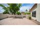 Lovely patio area with a paved walkway and a white stucco seat wall at 3166 E Desert Willow Rd, Phoenix, AZ 85048