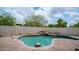 Beautiful backyard pool with rock waterfall feature and lush landscaping creating a serene oasis at 3166 E Desert Willow Rd, Phoenix, AZ 85048