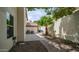 Well-maintained side yard with concrete slab, gravel, palm tree, and a wooden gate at 3166 E Desert Willow Rd, Phoenix, AZ 85048