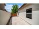 Exterior side yard showcasing a concrete patio and wooden gate at 3166 E Desert Willow Rd, Phoenix, AZ 85048