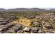 Stunning aerial view of the neighborhood featuring well-maintained homes, green spaces, and mountain views in the background at 3319 W Carter Rd, Phoenix, AZ 85041