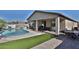 Resort-style backyard with pool, artificial turf, and covered patio offering the ultimate outdoor living space at 3319 W Carter Rd, Phoenix, AZ 85041