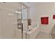 Modern bathroom featuring a glass-enclosed shower, soaking tub, and elegant fixtures and neutral decor at 3319 W Carter Rd, Phoenix, AZ 85041