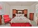 Cozy bedroom featuring a decorative bed frame, matching side tables and chair, with elegant bedding details at 3319 W Carter Rd, Phoenix, AZ 85041