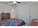 Cozy bedroom with ceiling fan, neutral walls, and a traditional dresser and quilt at 3319 W Carter Rd, Phoenix, AZ 85041