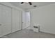 This bedroom is spacious, bright, and offers ample closet space with neutral-toned walls and soft carpet at 3319 W Carter Rd, Phoenix, AZ 85041