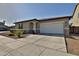 Well-maintained single-story home with a two-car garage, landscaped front yard and large driveway at 3319 W Carter Rd, Phoenix, AZ 85041