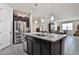 Kitchen island with granite countertop and sink, complemented by stainless steel appliances and dark wood cabinets at 3319 W Carter Rd, Phoenix, AZ 85041