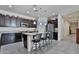 Modern kitchen with dark cabinets, granite countertops, stainless steel appliances, and an island with seating at 3319 W Carter Rd, Phoenix, AZ 85041