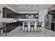 Modern kitchen with granite countertops, stainless steel appliances, a breakfast bar with seating at 3319 W Carter Rd, Phoenix, AZ 85041
