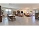 Open-concept living and dining area with tile flooring, abundant natural light, and neutral color palette at 3319 W Carter Rd, Phoenix, AZ 85041