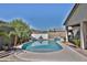 Outdoor pool and landscaped area with lush greenery, brick accents, and private fencing at 3319 W Carter Rd, Phoenix, AZ 85041