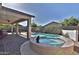 An outdoor pool and hot tub with mature landscaping, under the shade of a covered patio at 3319 W Carter Rd, Phoenix, AZ 85041