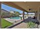Inviting backyard with a pool, outdoor seating, and desert landscaping under a shaded patio at 3319 W Carter Rd, Phoenix, AZ 85041