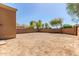 Spacious, dirt backyard with trees in the background and a block wall around the perimeter of the yard at 3532 S 160Th Ln, Goodyear, AZ 85338