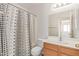 Well-lit bathroom featuring a shower, toilet, vanity, and decorative shower curtain at 3532 S 160Th Ln, Goodyear, AZ 85338