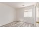 Bright bedroom with gray wood-look flooring and a window offering ample natural light at 3532 S 160Th Ln, Goodyear, AZ 85338