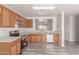Bright kitchen featuring wood cabinetry, stainless steel appliances and pass-through to the living room at 3532 S 160Th Ln, Goodyear, AZ 85338
