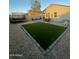 Landscaped backyard with artificial turf, paver patio, trampoline and seating area at 3602 N 300Th Dr, Buckeye, AZ 85396