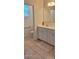 Bright bathroom featuring double sinks, white cabinetry, and tile flooring at 3602 N 300Th Dr, Buckeye, AZ 85396