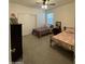 Neutral bedroom boasts twin beds with iron frames, closet with sliding doors and a ceiling fan at 3602 N 300Th Dr, Buckeye, AZ 85396