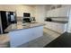 Bright kitchen with a center island, granite countertops, and modern stainless steel appliances at 3602 N 300Th Dr, Buckeye, AZ 85396