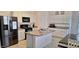 Modern kitchen featuring white cabinets, granite countertops, and stainless steel appliances at 3602 N 300Th Dr, Buckeye, AZ 85396