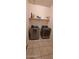 Functional laundry room features a full sized washer and dryer with a shelf at 3602 N 300Th Dr, Buckeye, AZ 85396