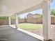 Covered patio overlooking a landscaped backyard with a fire pit area at 365 E Mountain View Rd, San Tan Valley, AZ 85143