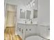 Bright bathroom featuring a dual sink vanity with modern fixtures and an open doorway at 365 E Mountain View Rd, San Tan Valley, AZ 85143