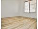 Bright bedroom features wood-look floors, a window, and neutral paint at 365 E Mountain View Rd, San Tan Valley, AZ 85143