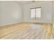 Bright and airy bedroom with wood floors, a large window, and neutral walls, creating a serene atmosphere at 365 E Mountain View Rd, San Tan Valley, AZ 85143