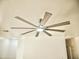 Close-up of a contemporary ceiling fan fixture in a large living room, showcasing the home's modern design at 365 E Mountain View Rd, San Tan Valley, AZ 85143
