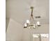 Elegant chandelier with glass shades and brass finish, adding a touch of sophistication to the room's lighting at 365 E Mountain View Rd, San Tan Valley, AZ 85143