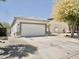 View of the home's facade with a large driveway leading to the two-car garage and neutral desert landscaping at 365 E Mountain View Rd, San Tan Valley, AZ 85143