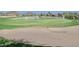 Expansive golf course with a sand trap, water feature, and lush green grass on a sunny day at 365 E Mountain View Rd, San Tan Valley, AZ 85143