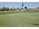 Well-maintained golf course with clear skies and community homes in the distance at 365 E Mountain View Rd, San Tan Valley, AZ 85143