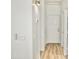 Bright hallway with wood floors, neutral walls, and modern lighting, leading to various rooms in the home at 365 E Mountain View Rd, San Tan Valley, AZ 85143