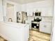 Beautiful white kitchen with stainless steel appliances and stylish countertops offers a modern, bright space at 365 E Mountain View Rd, San Tan Valley, AZ 85143