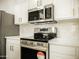 Modern kitchen featuring stainless steel appliances, white cabinets, and sleek countertops, a chef's dream at 365 E Mountain View Rd, San Tan Valley, AZ 85143