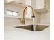 Modern kitchen sink with a gold faucet and tile backsplash that elevates style and adds visual interest at 365 E Mountain View Rd, San Tan Valley, AZ 85143