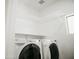 Well-organized laundry room with washer, dryer, and shelving for efficient storage and convenience at 365 E Mountain View Rd, San Tan Valley, AZ 85143