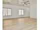 Bright and airy living room with wood-look floors, white walls, a ceiling fan, and natural light from large windows at 365 E Mountain View Rd, San Tan Valley, AZ 85143