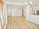 Open-concept living area with hardwood floors and modern lighting that is filled with natural light at 365 E Mountain View Rd, San Tan Valley, AZ 85143