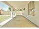 A long covered patio overlooks the grassy backyard beyond a block fence at 365 E Mountain View Rd, San Tan Valley, AZ 85143