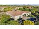 An aerial perspective highlights a residence featuring a pool, fire pit, and well-maintained grounds within the community at 37308 N 100Th Pl, Scottsdale, AZ 85262