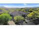 Aerial view showcases a home with lush desert landscaping, beautiful curb appeal, and a meticulously designed neighborhood at 37308 N 100Th Pl, Scottsdale, AZ 85262