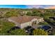 Expansive desert home features a pool, fire pit, outdoor kitchen, and landscaped backyard at 37308 N 100Th Pl, Scottsdale, AZ 85262