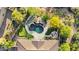 Aerial view of a backyard oasis featuring a custom pool, putting green, and a cozy fire pit area at 37308 N 100Th Pl, Scottsdale, AZ 85262